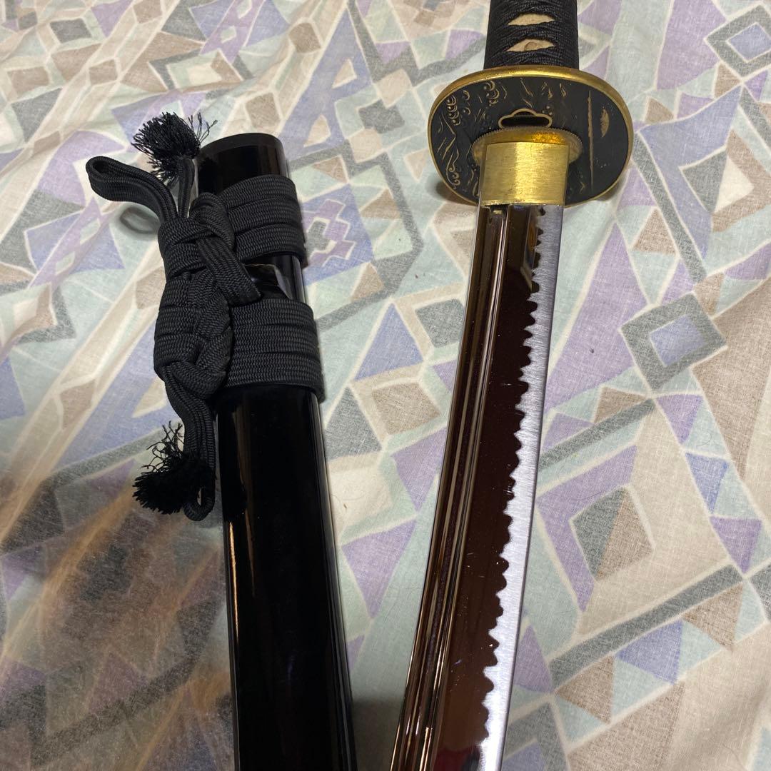 上級居合刀 黒柄 鶴波図楕円鍔 黒呂鞘